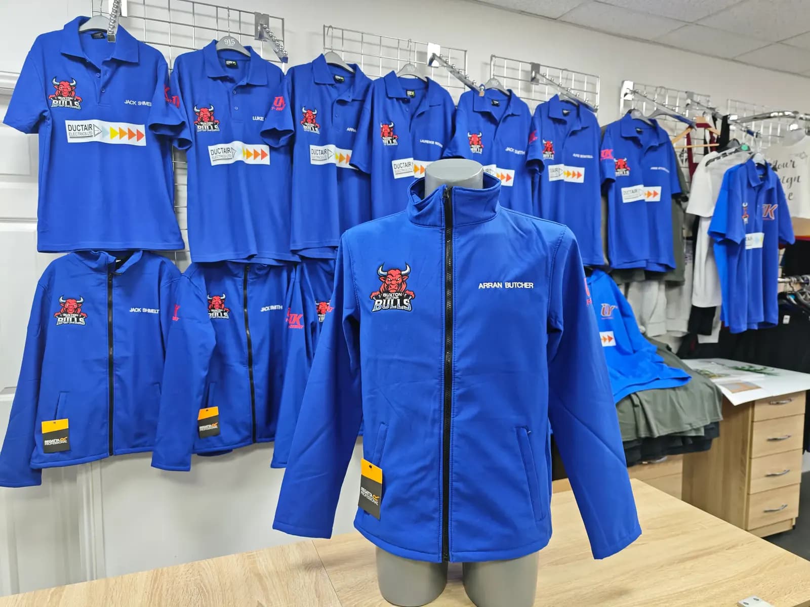 Buxton Bulls blue softshell jackets embroidered with club and sponsor logos
