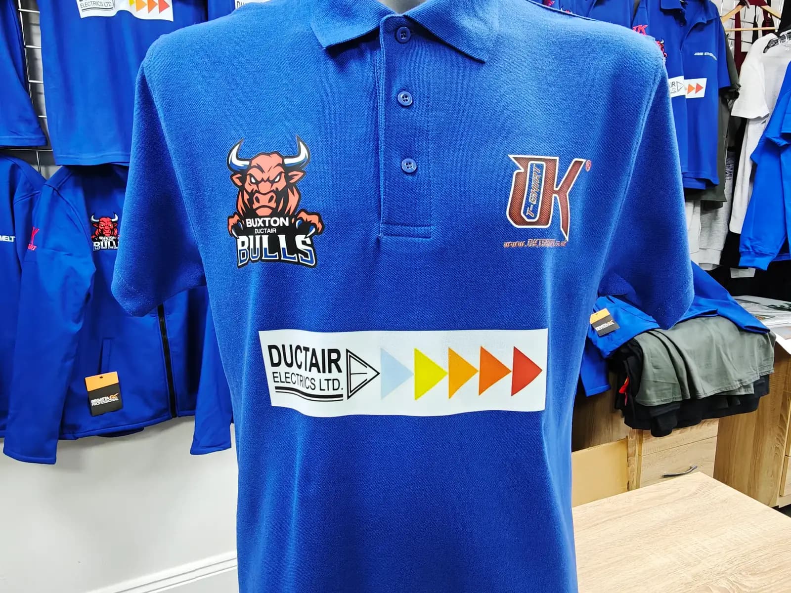 Named Buxton Bulls team polo with embroidered club crest and sponsor branding