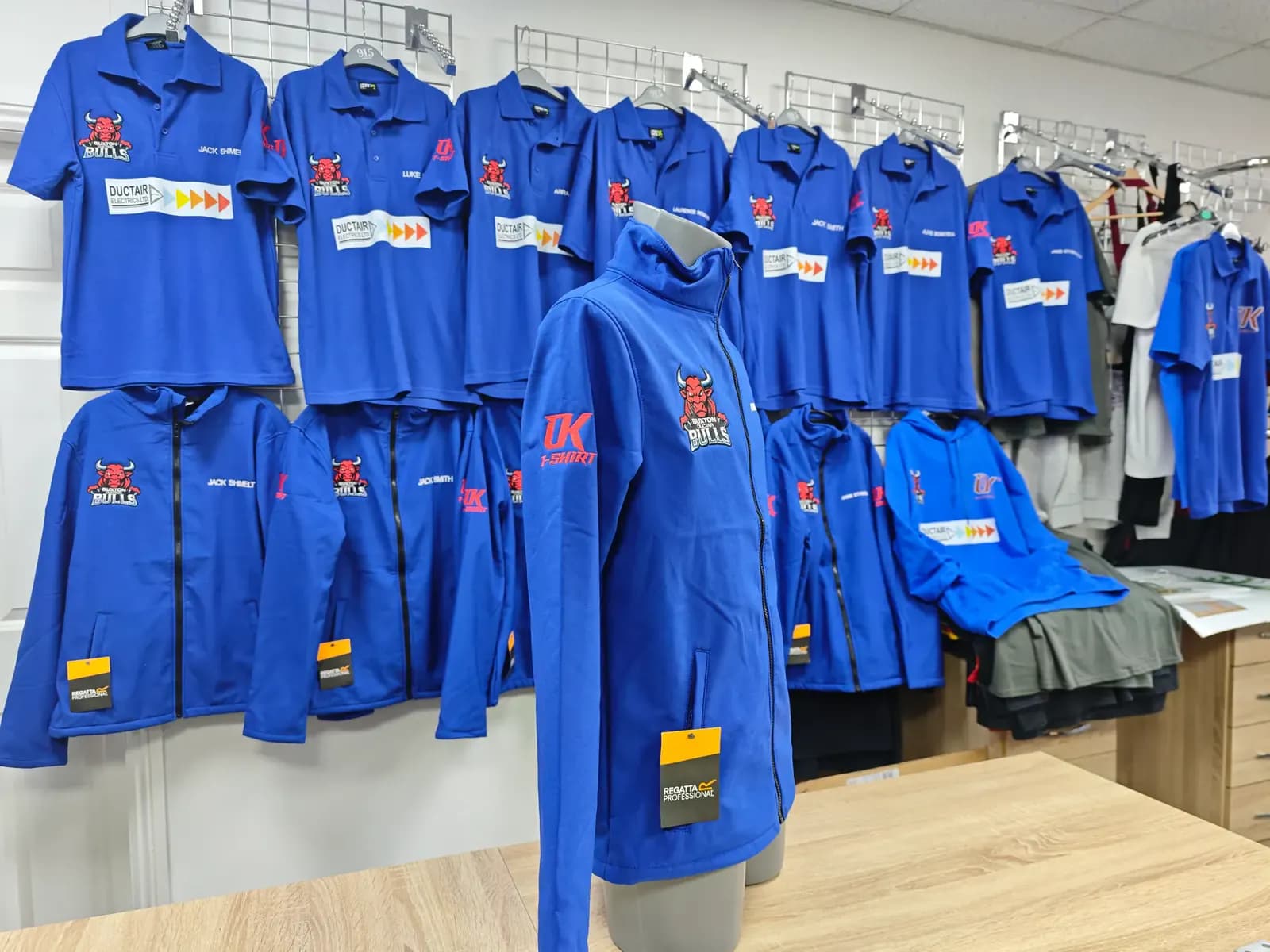 Blue Buxton Bulls embroidered jackets and team polos produced by OK T-Shirt