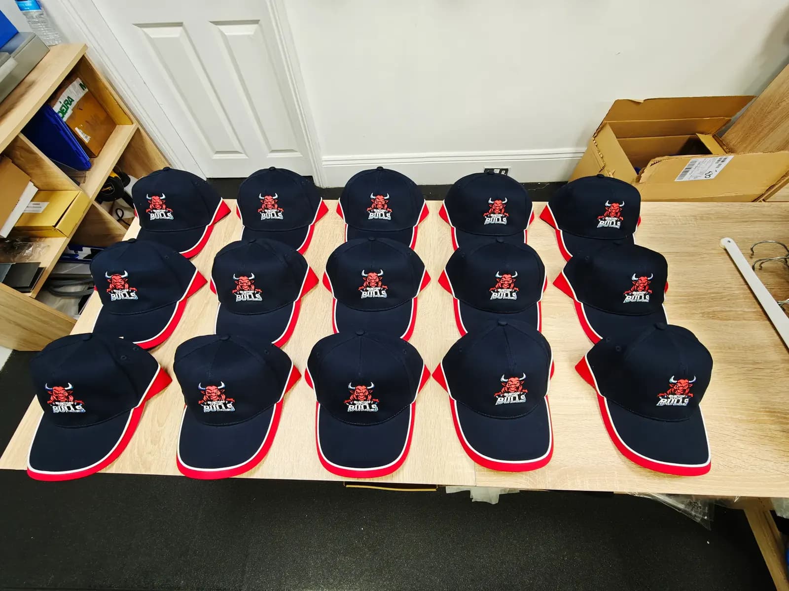Navy and red Buxton Bulls fan caps embroidered by OK T-Shirt