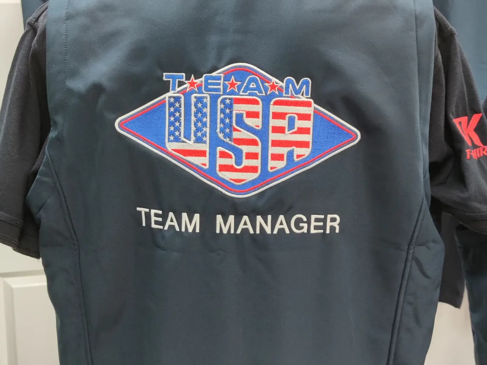 Collection of named embroidered speedway team polos produced by OK T-Shirt