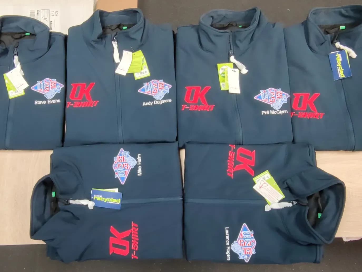 Named speedway polo shirts with embroidered team and sponsor logos