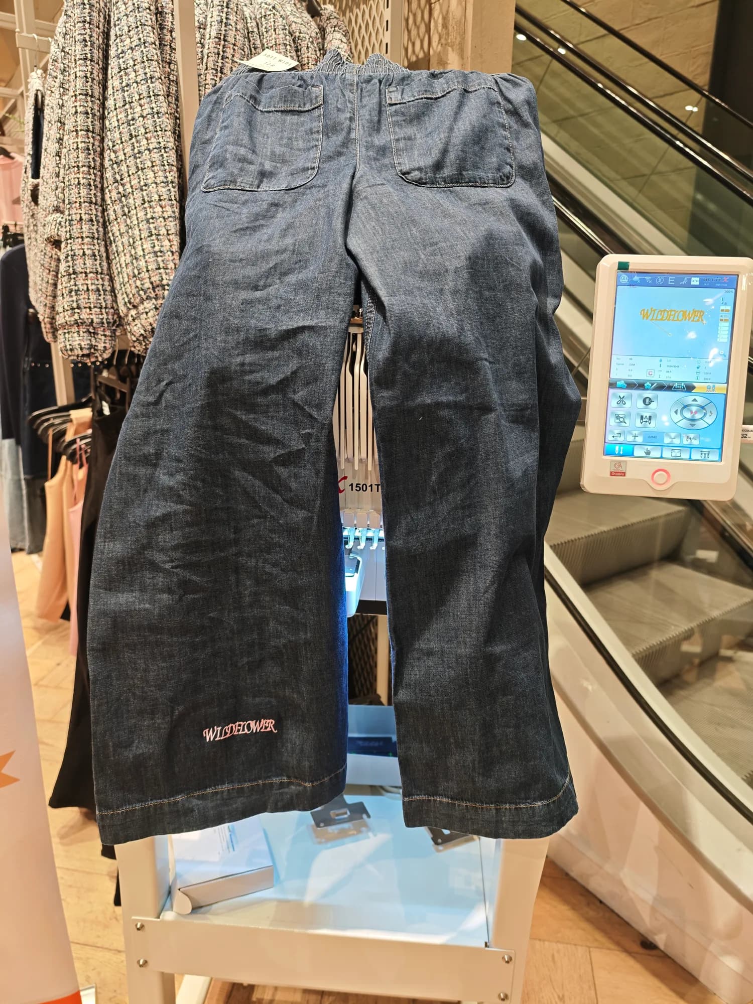Personalised River Island denim displayed beside the embroidery machine at Bullring